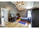 Cozy bedroom with wood floors, desk, ceiling fan, and a comfortable bed at 465 Harris Dr, Conyers, GA 30012
