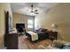 Charming bedroom with wood floors, desk area, ceiling fan, and comfortable bed at 465 Harris Dr, Conyers, GA 30012