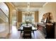 Open dining room with coffered ceilings, bay window, stylish lighting, and hardwood floors at 465 Harris Dr, Conyers, GA 30012