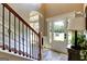 Bright foyer featuring hardwood floors, staircase with metal balusters, and view of the front door at 465 Harris Dr, Conyers, GA 30012