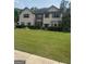 Charming two-story home with a well-manicured lawn and inviting front entrance at 465 Harris Dr, Conyers, GA 30012
