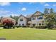 Charming home featuring a well-manicured lawn, complemented by lush greenery and neutral siding at 465 Harris Dr, Conyers, GA 30012