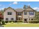 Inviting two-story home featuring a mix of neutral siding and brick, paired with blue shutters at 465 Harris Dr, Conyers, GA 30012