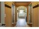 Hallway leading to a bathroom featuring wood flooring and architectural archways at 465 Harris Dr, Conyers, GA 30012