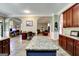 Large, open kitchen features a granite-topped island, dark wood cabinets, and tile flooring at 465 Harris Dr, Conyers, GA 30012