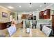 Kitchen boasts a breakfast bar with modern barstools, dark wood cabinets, and tile flooring at 465 Harris Dr, Conyers, GA 30012