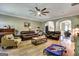 Spacious living room with hardwood floors, modern ceiling fan, and multiple leather sofas at 465 Harris Dr, Conyers, GA 30012