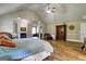 Spacious main bedroom with vaulted ceilings, wood floors, and a cozy fireplace at 465 Harris Dr, Conyers, GA 30012