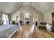 Generous main bedroom features a soaring ceiling, fireplace, and beautiful wood floors at 465 Harris Dr, Conyers, GA 30012
