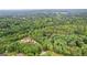 Expansive aerial view of the property featuring lush greenery, potential homesite, and natural beauty at 135 Birdsong Ln, Fayetteville, GA 30215