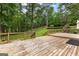 Multi-tiered backyard with landscaping, a fenced area, and wooded views at 135 Birdsong Ln, Fayetteville, GA 30215
