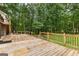 Wooden deck and railing overlooking a secluded backyard surrounded by lush greenery at 135 Birdsong Ln, Fayetteville, GA 30215