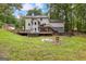 Beautiful backyard view of a two-story home with a large deck and fire pit at 135 Birdsong Ln, Fayetteville, GA 30215