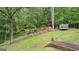 Large backyard features a storage shed, chicken coop, and a trampoline at 135 Birdsong Ln, Fayetteville, GA 30215