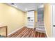 Basement room with vinyl floors, a white bookshelf, and neutral yellow paint on the walls at 135 Birdsong Ln, Fayetteville, GA 30215