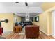 Finished basement with vinyl flooring, featuring a leather sectional sofa, and windows with backyard views at 135 Birdsong Ln, Fayetteville, GA 30215
