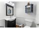 Bathroom includes toilet, sink, decorative mirror and a cabinet for storage at 135 Birdsong Ln, Fayetteville, GA 30215