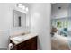Bathroom view through door features a single sink vanity and charming wainscoting at 135 Birdsong Ln, Fayetteville, GA 30215