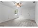 Neutral bedroom with a ceiling fan, carpeted floors, and bright natural light at 135 Birdsong Ln, Fayetteville, GA 30215