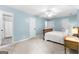 Carpeted bedroom with multiple doors and a view of an ensuite bathroom at 135 Birdsong Ln, Fayetteville, GA 30215