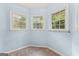 A bright bedroom offers a tranquil atmosphere with its three large windows at 135 Birdsong Ln, Fayetteville, GA 30215