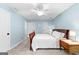 Bedroom features neutral walls, carpet floors, ceiling fan, and 2 door storage access at 135 Birdsong Ln, Fayetteville, GA 30215
