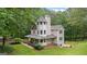 Charming two-story home with a wraparound porch, turret and a beautiful landscaped yard at 135 Birdsong Ln, Fayetteville, GA 30215