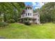 Charming two-story home with a inviting wraparound porch and well-maintained lawn at 135 Birdsong Ln, Fayetteville, GA 30215