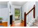 Inviting foyer with hardwood floors, staircase and a light blue accent wall at 135 Birdsong Ln, Fayetteville, GA 30215