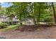 View of a home featuring a gazebo and lush green lawn, surrounded by mature trees at 135 Birdsong Ln, Fayetteville, GA 30215