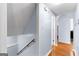 Hallway with hardwood floors leading to other rooms, featuring light blue paint and white trim at 135 Birdsong Ln, Fayetteville, GA 30215
