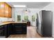 Bright kitchen features custom cabinets, stainless steel fridge, and large windows overlooking the backyard at 135 Birdsong Ln, Fayetteville, GA 30215