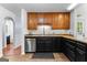 Well-lit kitchen showcasing stainless steel appliances and black cabinets with tan countertops at 135 Birdsong Ln, Fayetteville, GA 30215