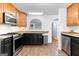 Kitchen includes stainless steel stove, microwave, dishwasher, tan countertops and a view into the next room at 135 Birdsong Ln, Fayetteville, GA 30215