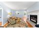 Spacious living room with hardwood floors, fireplace, and archways to other rooms at 135 Birdsong Ln, Fayetteville, GA 30215