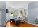 Cozy bay window seating area with two floral chairs, ottomans, and a picturesque view at 135 Birdsong Ln, Fayetteville, GA 30215