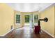 Bright room features a red wood stove, two windows, and door with backyard access at 135 Birdsong Ln, Fayetteville, GA 30215