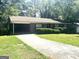 Inviting single-story brick home with a covered carport and long driveway at 2820 Lloyd Rd, Decatur, GA 30034