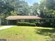 Charming single-story brick home featuring a covered carport and mature landscaping at 2820 Lloyd Rd, Decatur, GA 30034