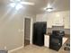 Bright kitchen with white cabinets, black appliances, and tile flooring at 2820 Lloyd Rd, Decatur, GA 30034