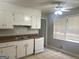 Bright kitchen features a double sink, white appliances, and ample cabinet space at 2820 Lloyd Rd, Decatur, GA 30034