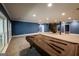 Spacious basement with pool table, carpeted floor, and stone-accented stairs, perfect for recreation at 5780 Pumkintown Rd, Douglasville, GA 30135