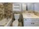 Bathroom featuring a white vanity, toilet, shower/tub combo, and a neutral-colored tiled wall at 5780 Pumkintown Rd, Douglasville, GA 30135