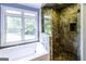 Stylish bathroom with soaking tub and luxurious tile shower, offering a spa-like experience at 5780 Pumkintown Rd, Douglasville, GA 30135