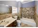 Bathroom featuring a dark wood vanity, toilet, tub/shower combo with neutral colored tiled wall at 5780 Pumkintown Rd, Douglasville, GA 30135