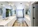 Bright bathroom featuring double vanity, ample mirror space, and a comfortable window seat at 5780 Pumkintown Rd, Douglasville, GA 30135
