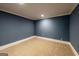 Cozy bedroom featuring neutral carpet, and blue painted walls at 5780 Pumkintown Rd, Douglasville, GA 30135