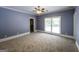 Spacious bedroom with light blue walls, carpet, ceiling fan, and double window view at 5780 Pumkintown Rd, Douglasville, GA 30135