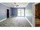 Large bedroom with carpet, light blue walls, ceiling fan, and windows; bathroom attached at 5780 Pumkintown Rd, Douglasville, GA 30135