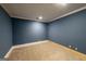 Cozy bedroom featuring neutral carpet, white trim, and blue painted walls at 5780 Pumkintown Rd, Douglasville, GA 30135
